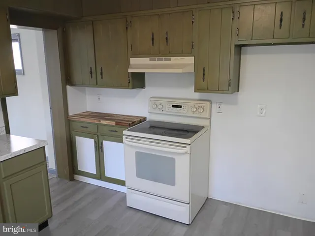 a kitchen with stainless steel appliances granite countertop a sink a stove a microwave and cabinets