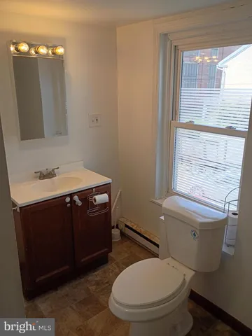 a view of an empty room with a kitchen
