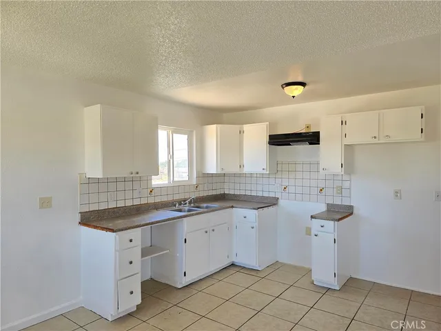 a kitchen with a sink cabinets and window