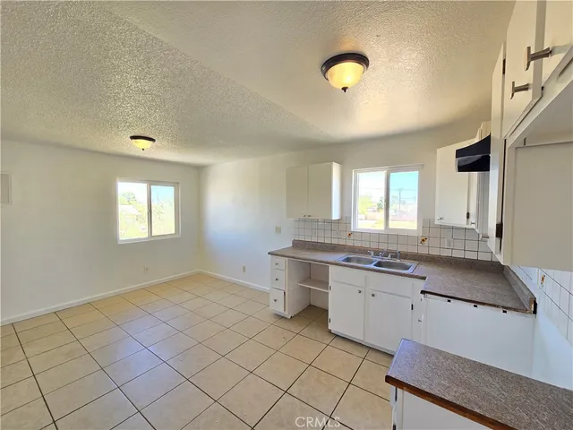 a view of a kitchen with a sink and a window