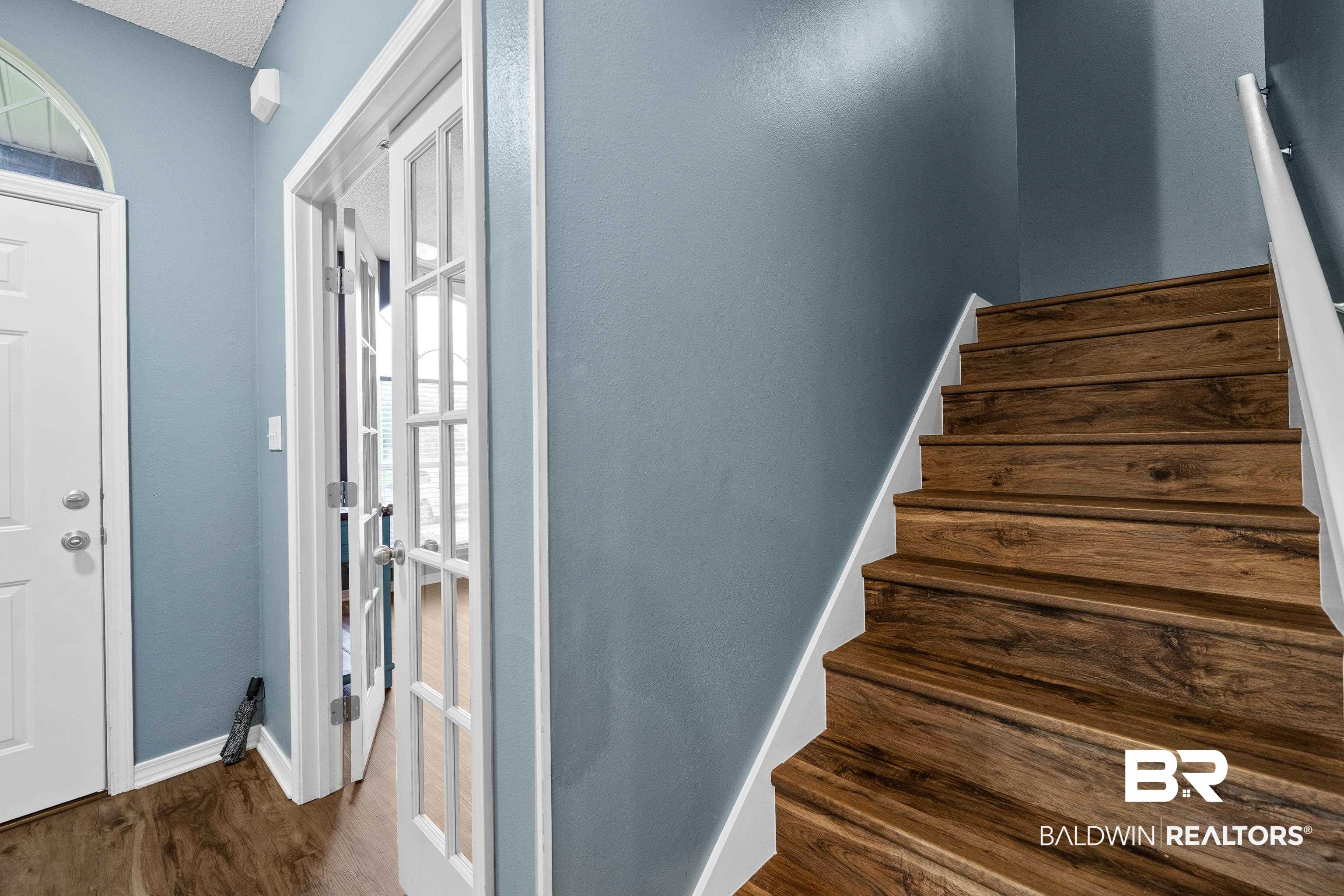 9552 Collier Loop Daphne, AL 36526 - Photo 11 of 28 Staircase with wood finished floors and baseboards