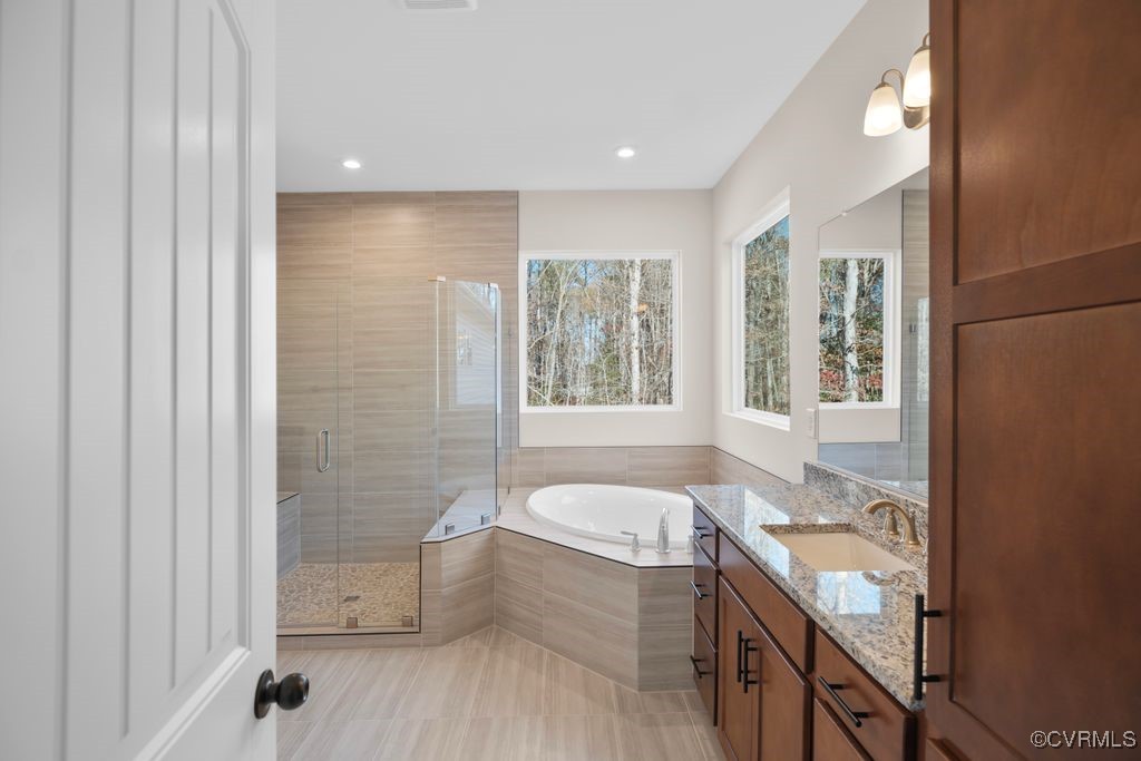 9254 Moldova Road Chesterfield, VA 23832 - Photo 31 of 49 a bathroom with a granite countertop tub a sink and a large window