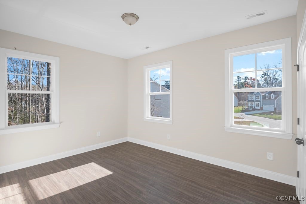 9254 Moldova Road Chesterfield, VA 23832 - Photo 36 of 49 a view of an empty room with wooden floor and a window