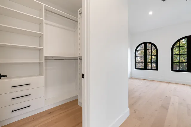 a view of empty room with wooden floor