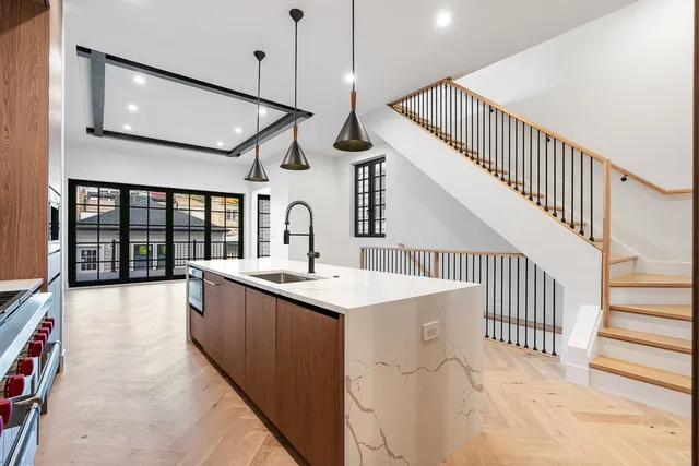 a kitchen with sink and mirror