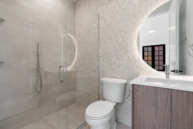a bathroom with a toilet sink and shower