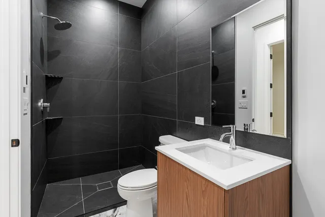 a bathroom with a sink toilet and shower