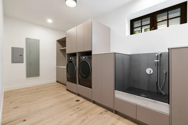 a view of kitchen with stainless steel appliances wooden floor and sink