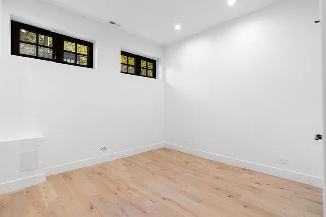 a view of a room with wooden floor and window