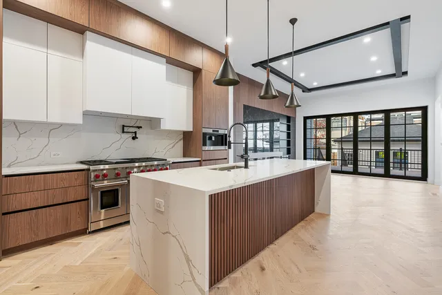 a kitchen with stainless steel appliances granite countertop a sink a stove and a refrigerator