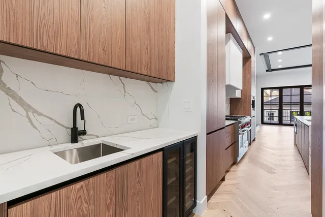 a kitchen with stainless steel appliances granite countertop a sink and dishwasher a oven with wooden cabinets