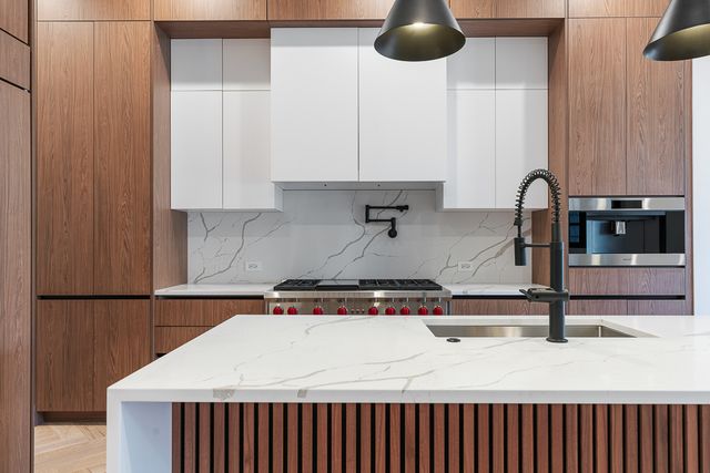 a kitchen with a sink and cabinets