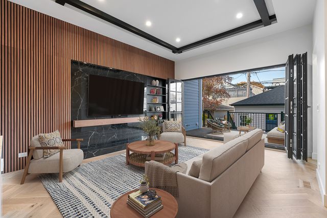 a living room with furniture a large window and a flat screen tv