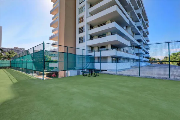 a front view of a multi story building with yard
