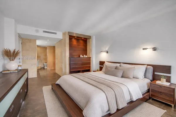 a bedroom with a bed and a couch