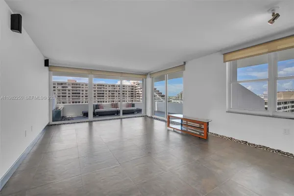 a view of empty room with wooden floor and floor to ceiling window