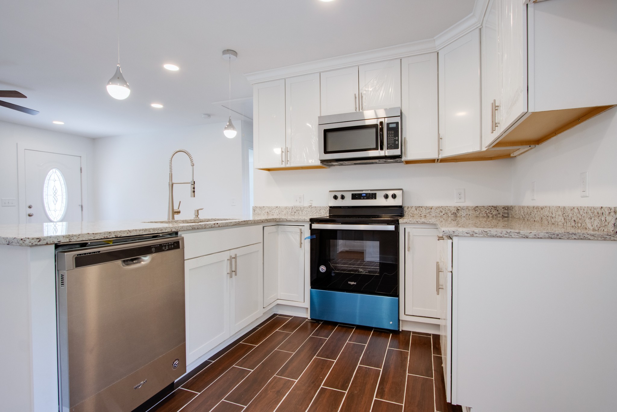 300 Randy Road Madison, TN 37115 - Photo 11 of 36 a kitchen with stainless steel appliances granite countertop a stove a sink and a microwave