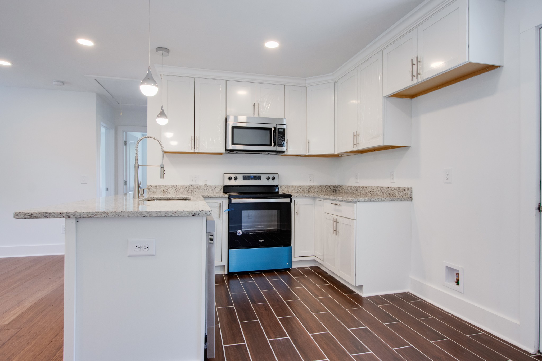 300 Randy Road Madison, TN 37115 - Photo 13 of 36 a kitchen with granite countertop white cabinets and stainless steel appliances