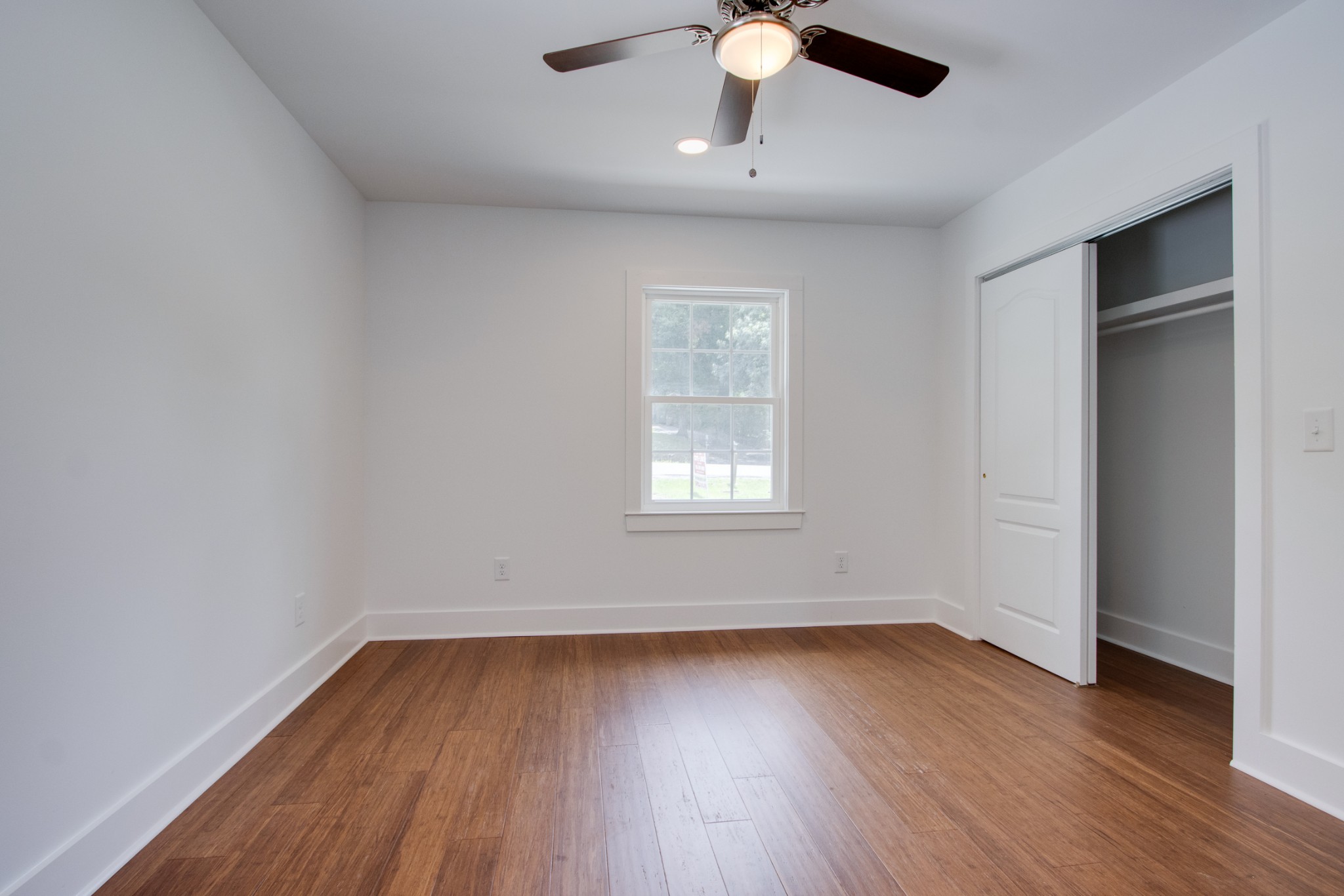 300 Randy Road Madison, TN 37115 - Photo 16 of 36 an empty room with wooden floor chandelier fan and windows