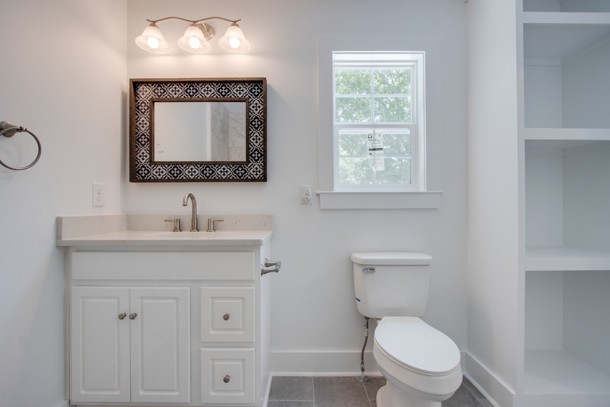 300 Randy Road Madison, TN 37115 - Photo 21 of 36 a bathroom with a toilet a sink a vanity and mirror