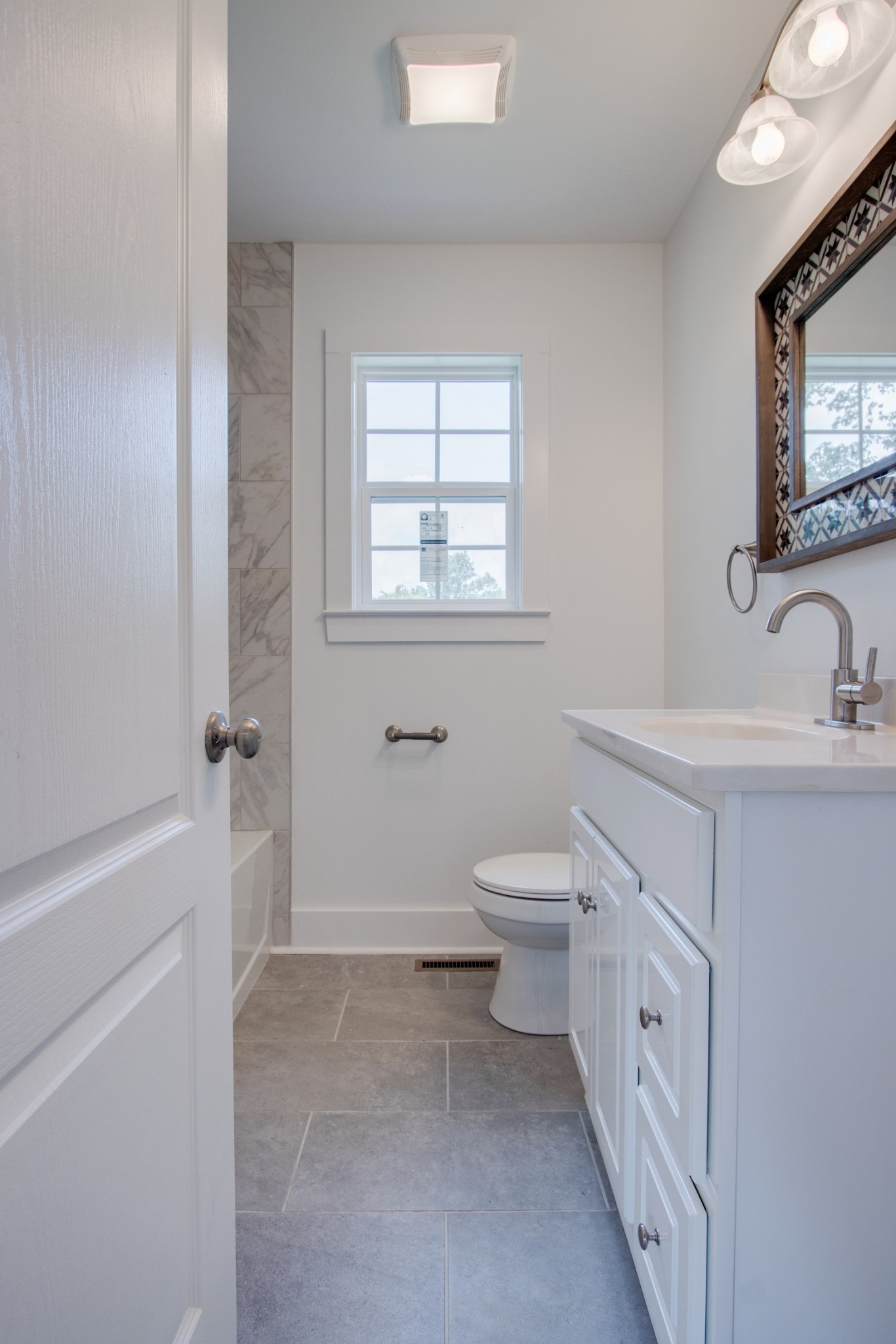 300 Randy Road Madison, TN 37115 - Photo 25 of 36 a bathroom with a double vanity sink a mirror and a toilet