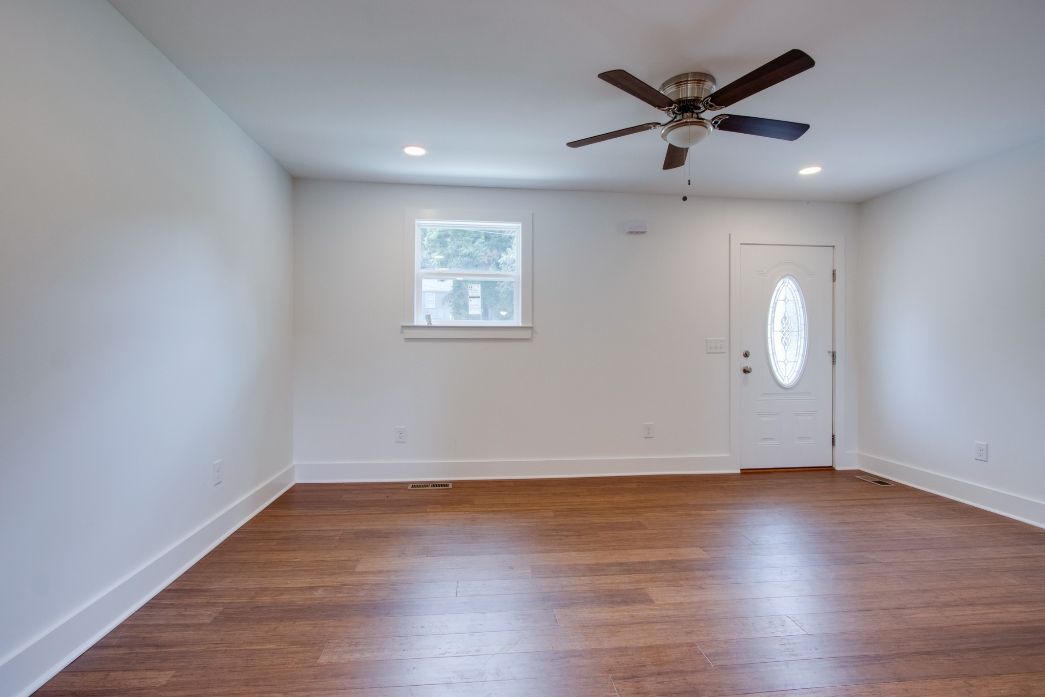 300 Randy Road Madison, TN 37115 - Photo 6 of 36 an empty room with wooden floor and windows