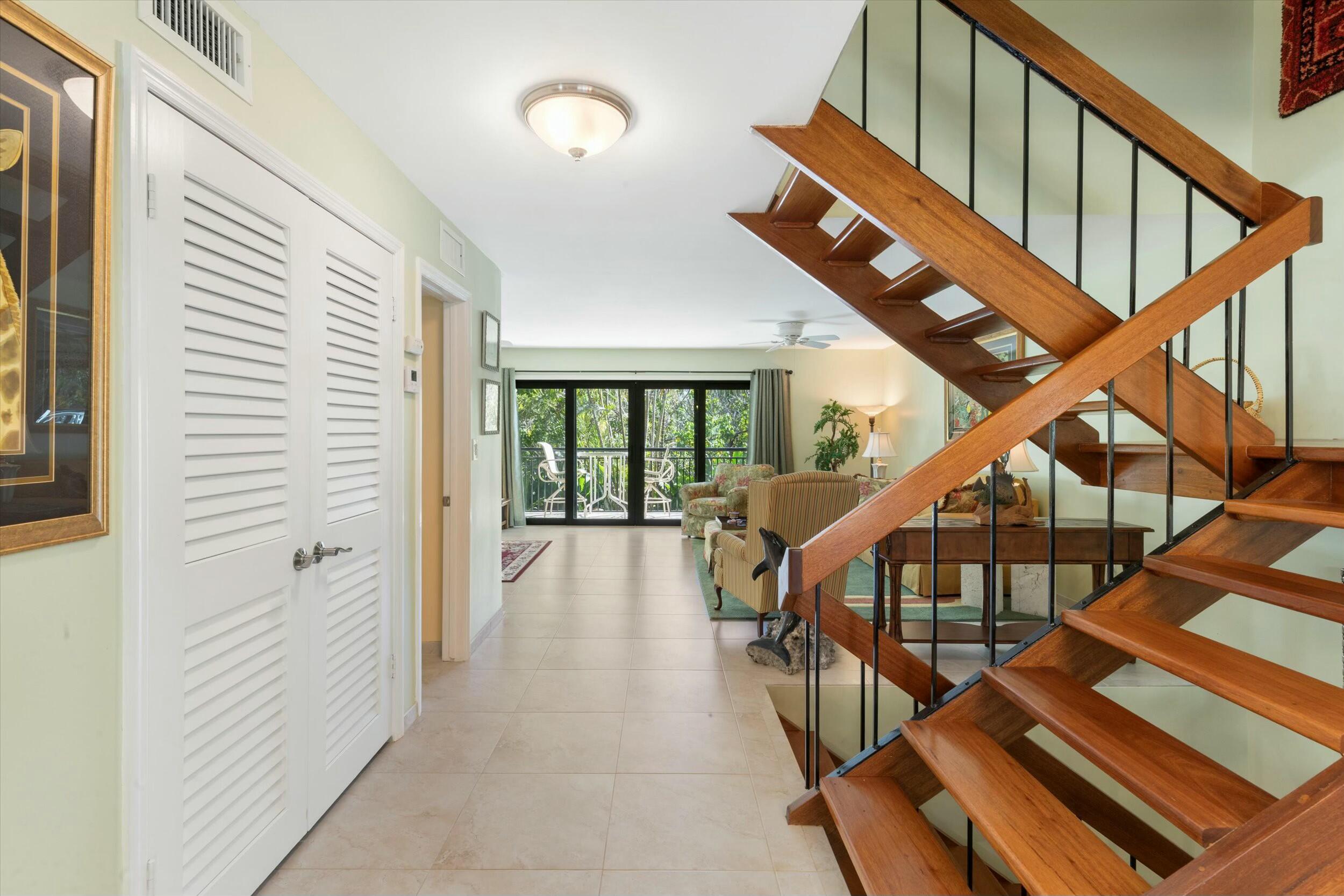 1616 Atlantic Boulevard, Unit 13 Key West, FL 33040 - Photo 8 of 38 a view of staircase with wooden floor and white walls