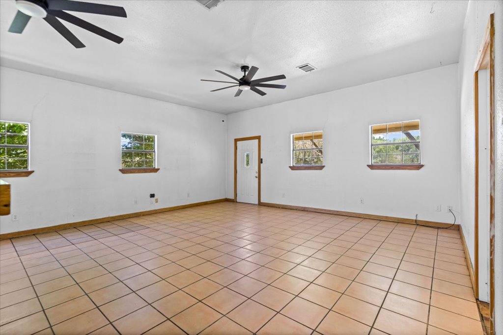 555 Harmon Hills Road, Unit A Dripping Springs, TX 78620 - Photo 12 of 29 A spacious room offers comfortable living with ample natural light from multiple windows.