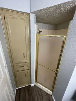 a view of a storage and utility room with refrigerator
