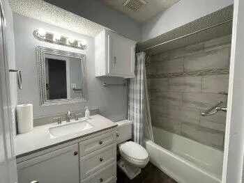 a bathroom with a sink toilet and shower