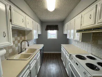 a kitchen that has a sink and a stove