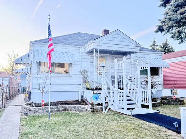 a front view of house with a garden