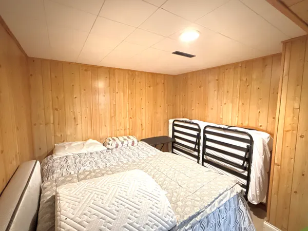 a bedroom with a bed and a mirror