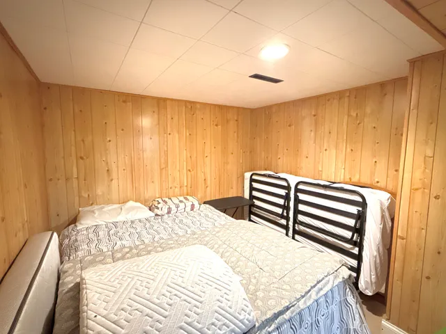 a bedroom with a bed and a mirror