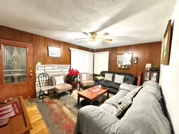 a living room with furniture fireplace and a large window