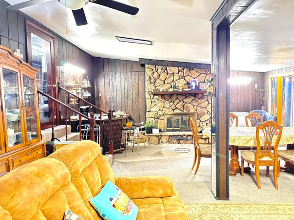 a living room with lots of furniture and a large window