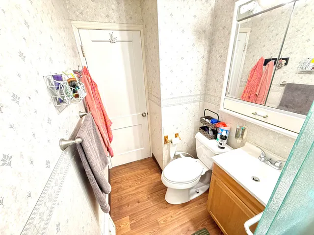 a bathroom with a sink toilet and shower