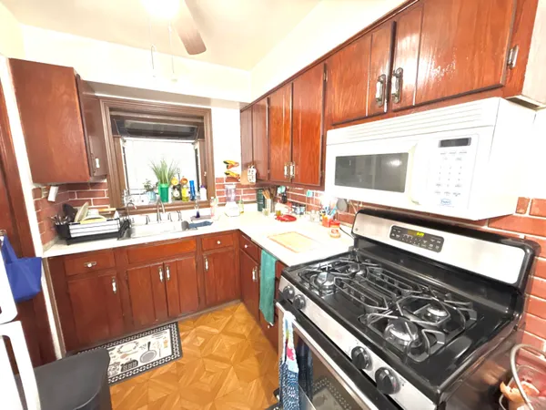 a kitchen with a stove a sink and a cabinets