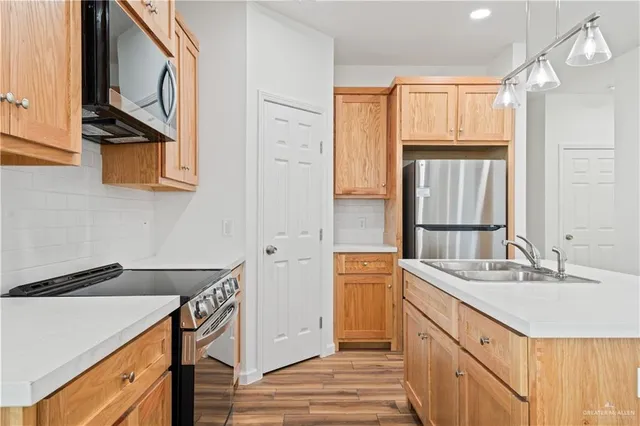 a kitchen with a sink appliances and cabinets