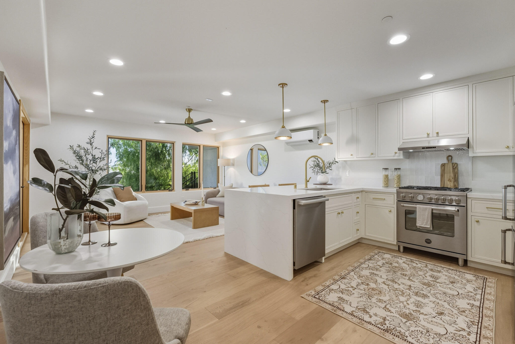 210 Las Alturas Road Santa Barbara, CA 93103 - Photo 43 of 61 a kitchen with a sink stove and white cabinets with wooden floor