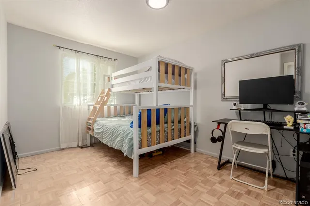 a bedroom with furniture and a flat screen tv