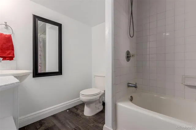 a bathroom with a toilet and bathtub