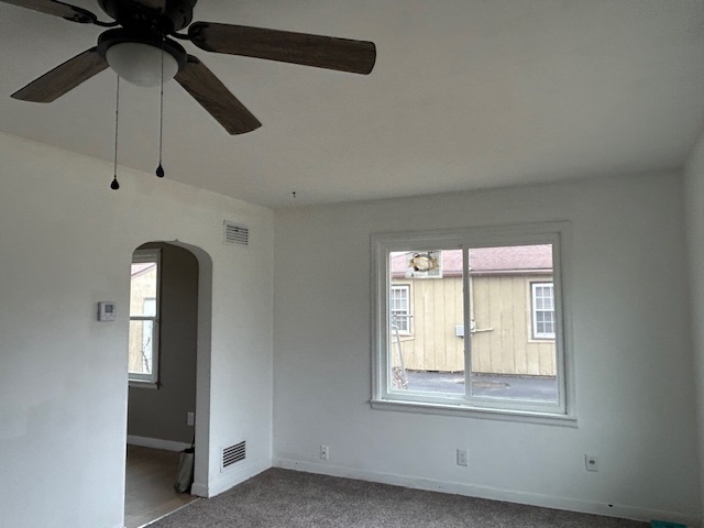 4715 50th Avenue Moline, IL 61265 - Photo 13 of 22 an empty room with a window and a ceiling fan