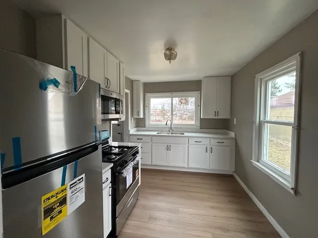 a kitchen with a refrigerator and a stove