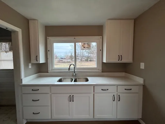 a kitchen with cabinets appliances and a sink
