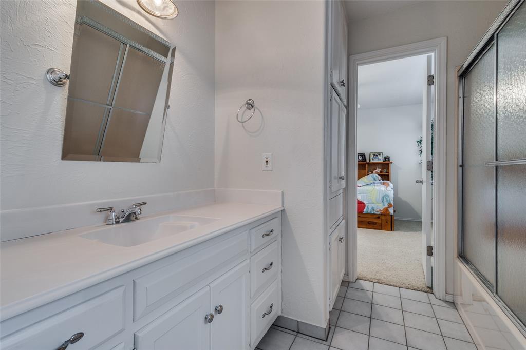 10 Biltmore Court Trophy Club, TX 76262 - Photo 20 of 25 a bathroom with a sink and a mirror