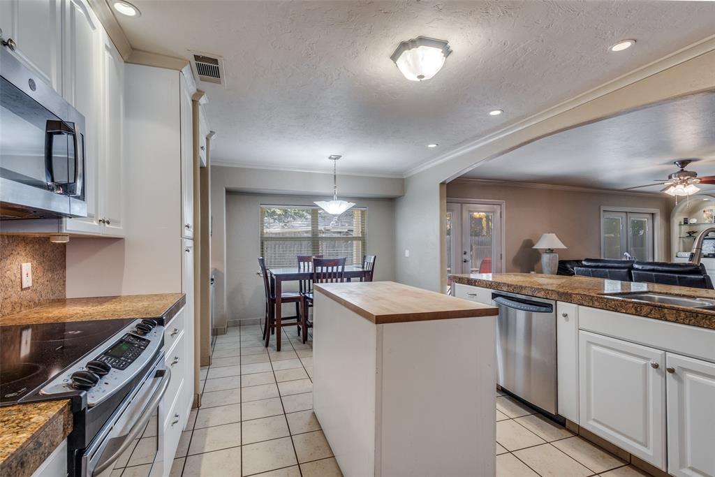 10 Biltmore Court Trophy Club, TX 76262 - Photo 6 of 25 a kitchen with white cabinets and appliances