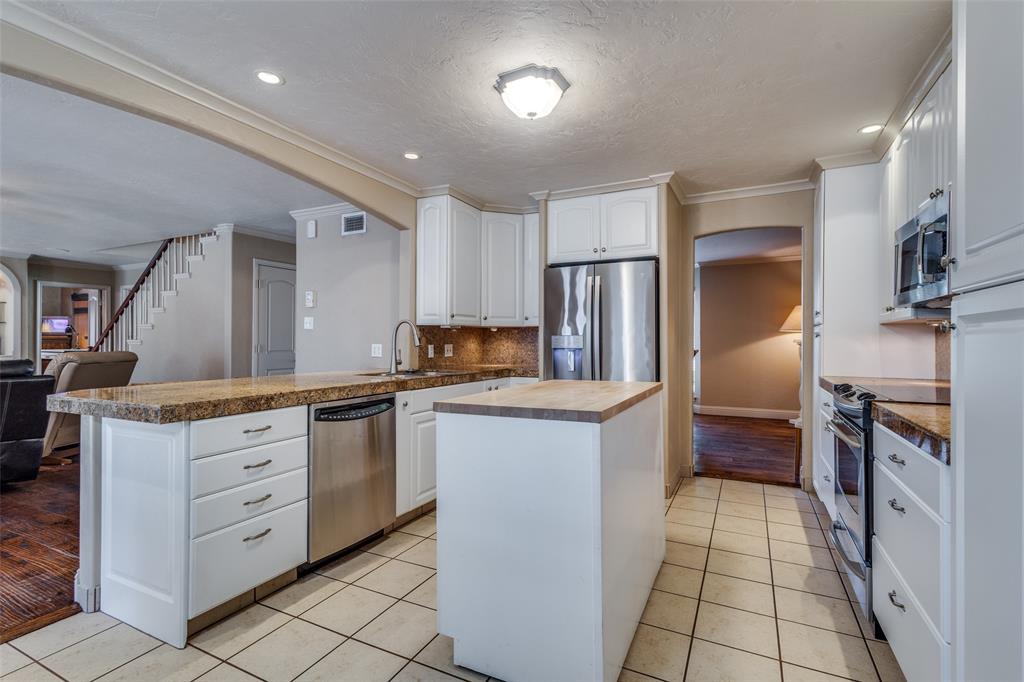 10 Biltmore Court Trophy Club, TX 76262 - Photo 7 of 25 a kitchen with stainless steel appliances kitchen island granite countertop a refrigerator and a stove top oven