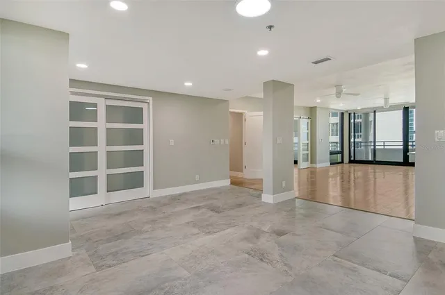a large white kitchen with refrigerator and a sink
