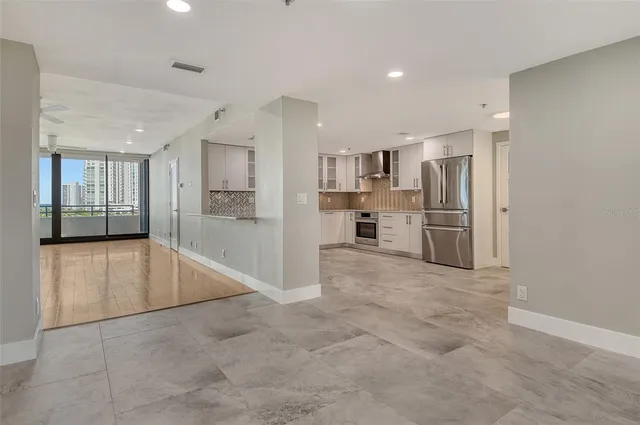 an empty room with windows and closet